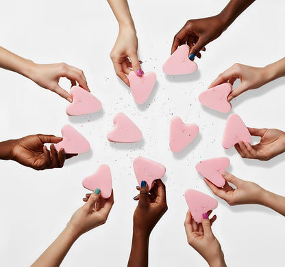 Multiple hands holding FemmeFlo menstrual sponges against a white background